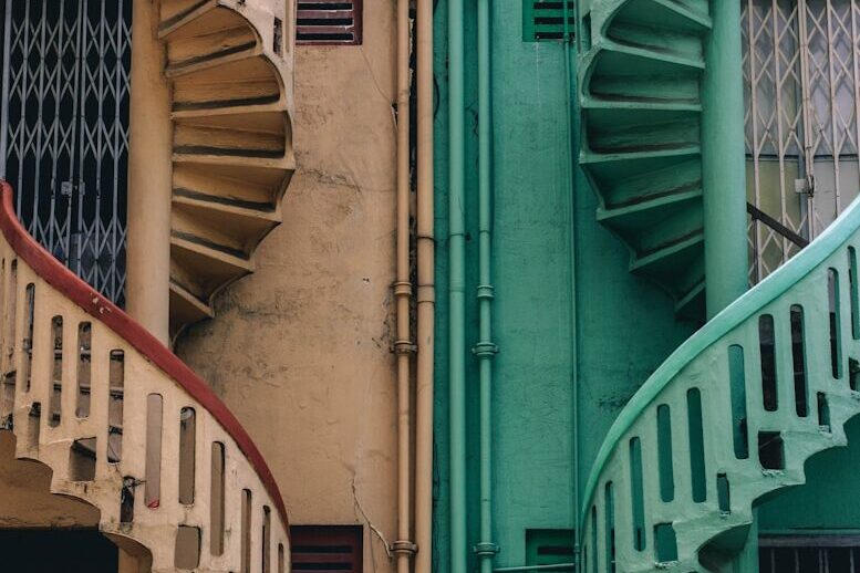 beige and green concrete spiral stairs beside building